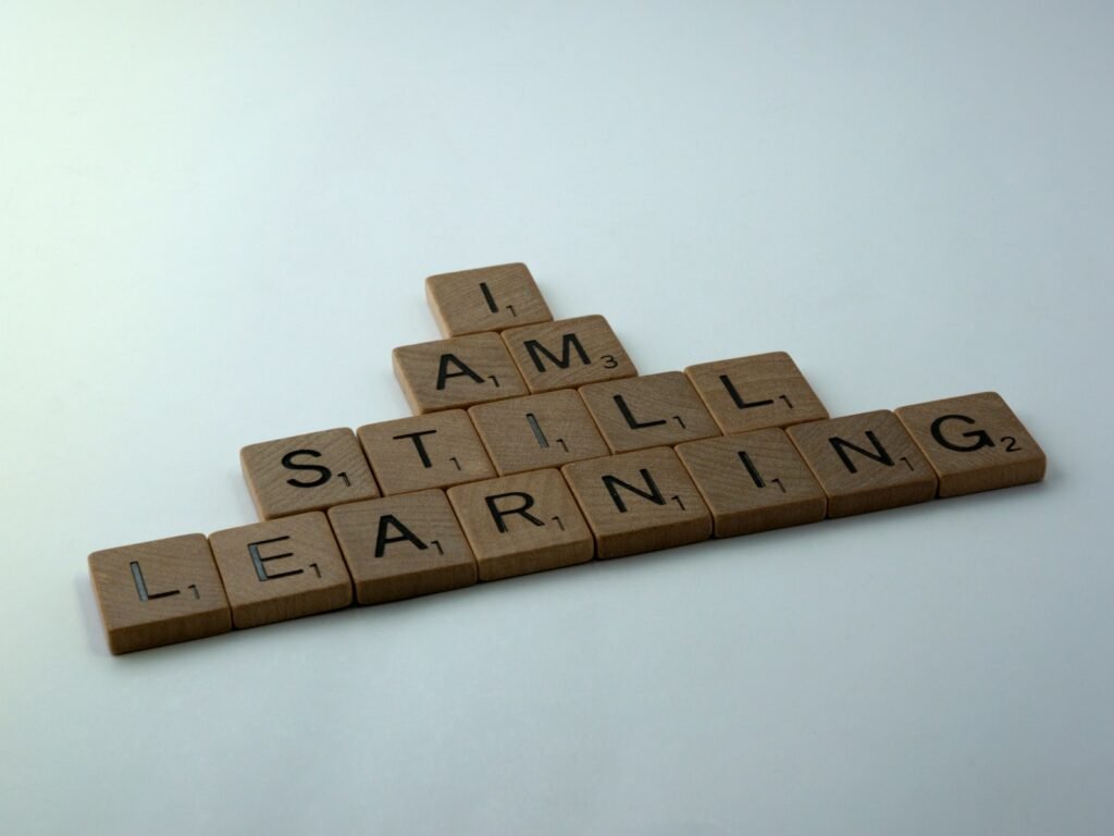 用字母拼字遊戲的木塊拼出「I AM STILL LEARNING」（我仍在學習）。